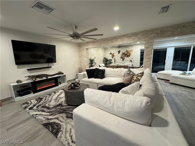 living room featuring hardwood / wood-style floors and ceiling fan