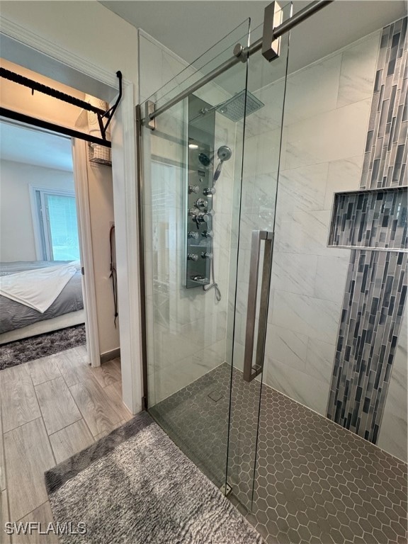 bathroom featuring hardwood / wood-style flooring and an enclosed shower