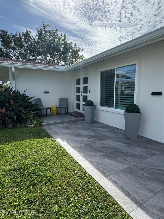 rear view of house with a yard and a patio area