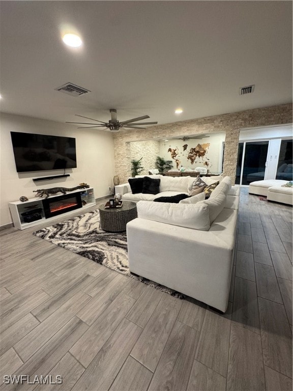 living room with hardwood / wood-style flooring and ceiling fan