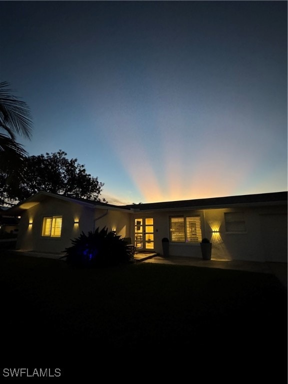 view of back house at dusk