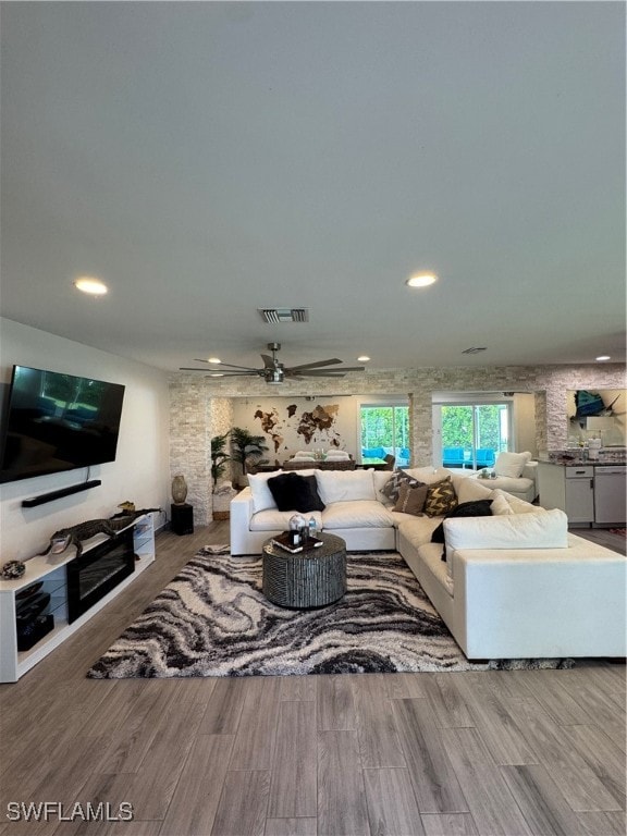 living room featuring hardwood / wood-style floors and ceiling fan