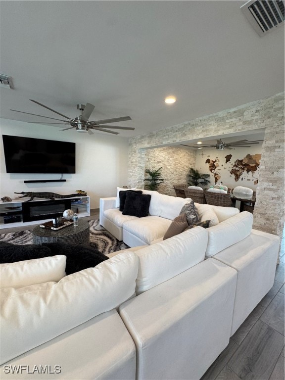 living room with wood-type flooring and ceiling fan