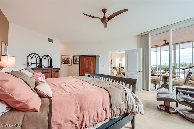 bedroom featuring ceiling fan, light hardwood / wood-style floors, floor to ceiling windows, and access to outside