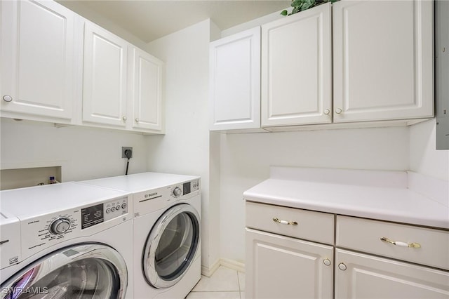 170 Lenell Rd Unit 501, Fort Myers Beach, FL 33931 - laundry area featuring cabinet space, independent washer and dryer, light tile patterned flooring, and baseboards