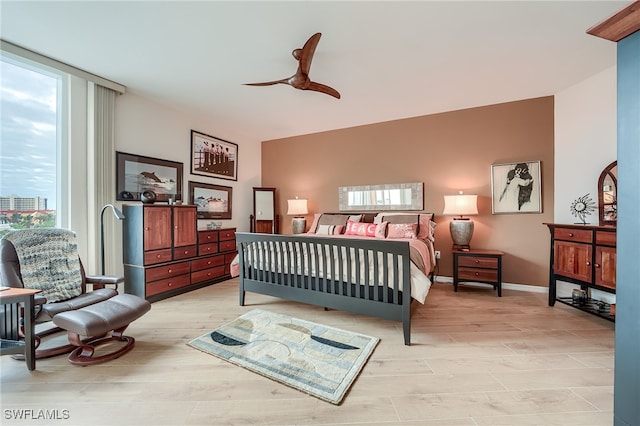 bedroom with ceiling fan and light hardwood / wood-style flooring