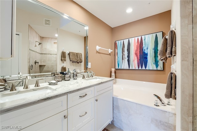 bathroom featuring vanity and plus walk in shower