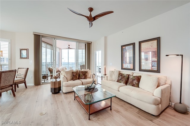 living room featuring light hardwood / wood-style floors and ceiling fan