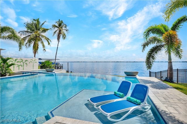 view of pool with a water view