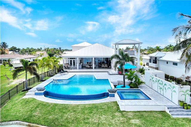 view of pool with a lawn, a gazebo, and an in ground hot tub