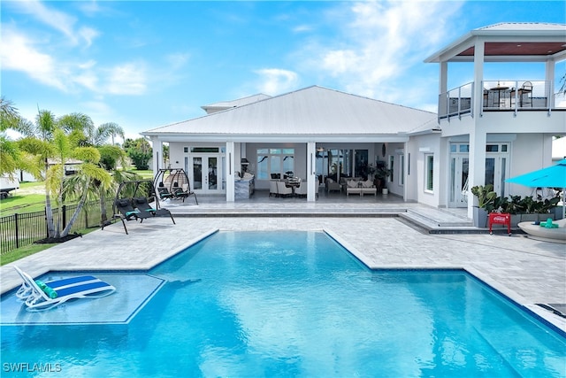 view of pool featuring an outdoor hangout area, a patio, and french doors