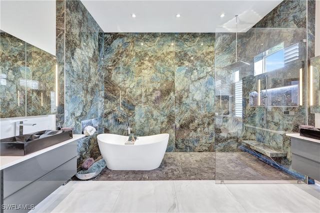 bathroom featuring vanity, separate shower and tub, and tile walls