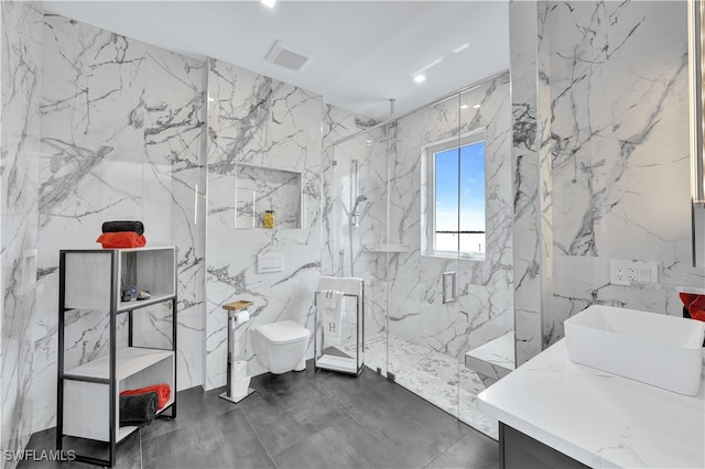 bathroom featuring toilet, a tile shower, and vanity