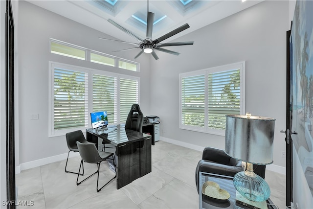 office featuring beamed ceiling, plenty of natural light, ceiling fan, and coffered ceiling