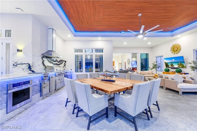 dining room featuring a raised ceiling, ceiling fan, and wood ceiling