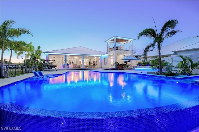 view of pool at dusk