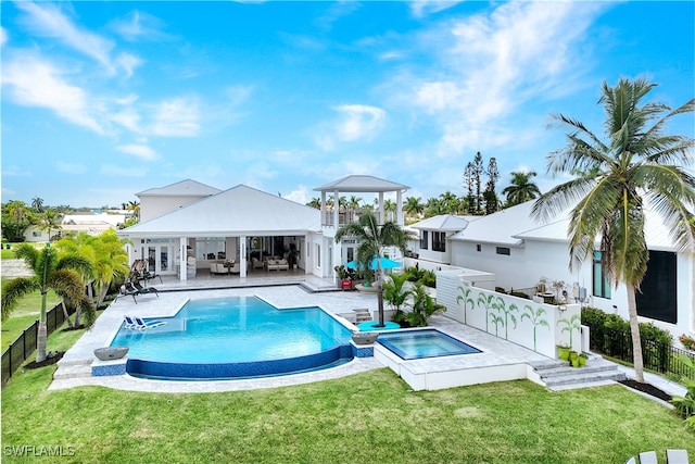 view of swimming pool with an in ground hot tub, a yard, an outdoor hangout area, and a patio area