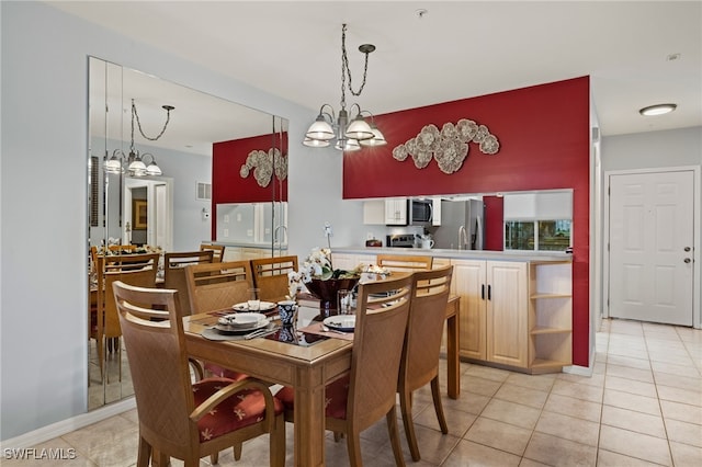 tiled dining area featuring a chandelier