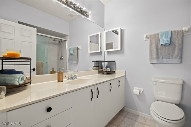 bathroom featuring tile patterned floors, toilet, an enclosed shower, and vanity