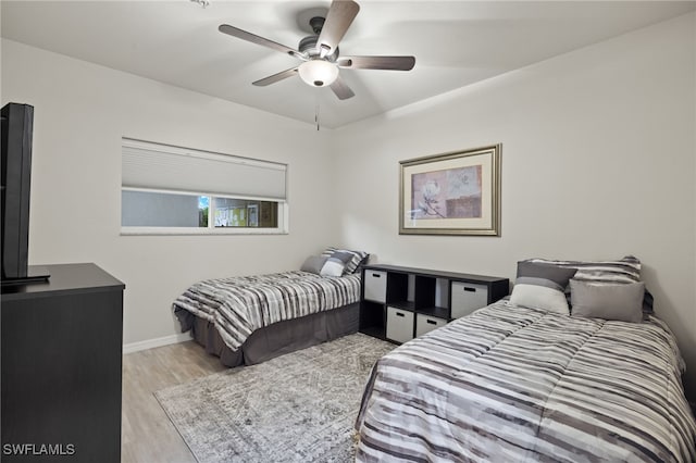 bedroom with ceiling fan and light wood-type flooring