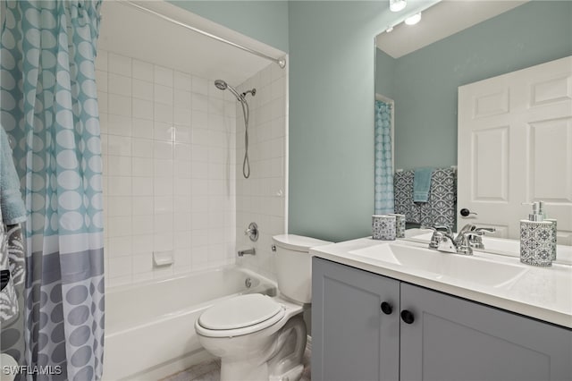 full bathroom with vanity, shower / tub combo, and toilet