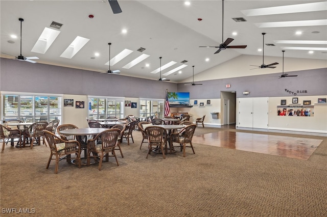 dining space featuring carpet floors, ceiling fan, and high vaulted ceiling