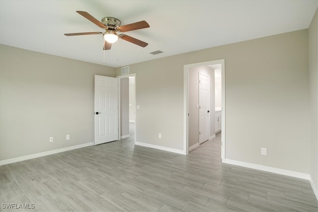 empty room with ceiling fan and light wood-type flooring