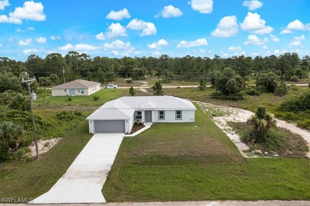 2902 40th St W, Lehigh Acres, FL 33971 - view of front of house with driveway, a front lawn, a view of trees, and an attached garage