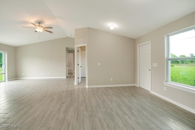 2902 40th St W, Lehigh Acres, FL 33971 - empty room with light wood-type flooring, ceiling fan, vaulted ceiling, and baseboards