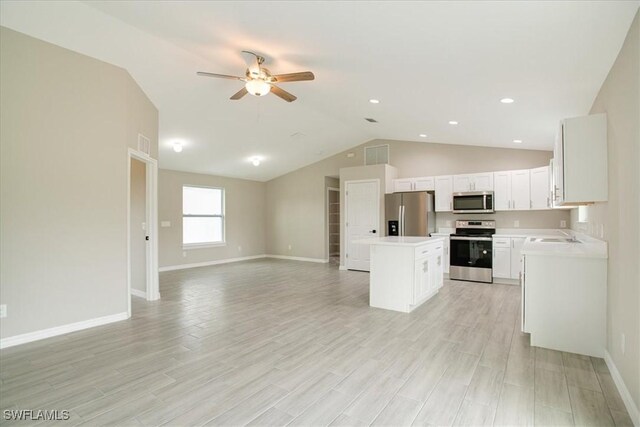 2902 40th St W, Lehigh Acres, FL 33971 - kitchen with appliances with stainless steel finishes, open floor plan, a center island, ceiling fan, and lofted ceiling