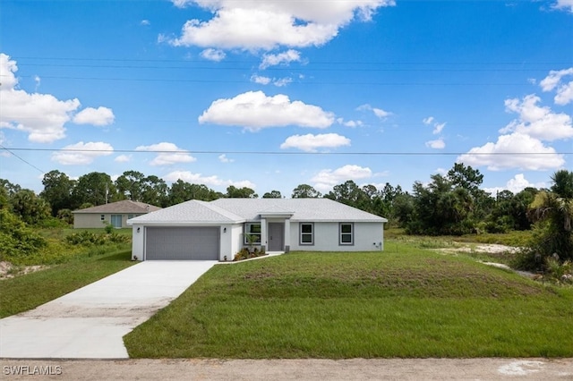 view of front of property with a garage and a front lawn