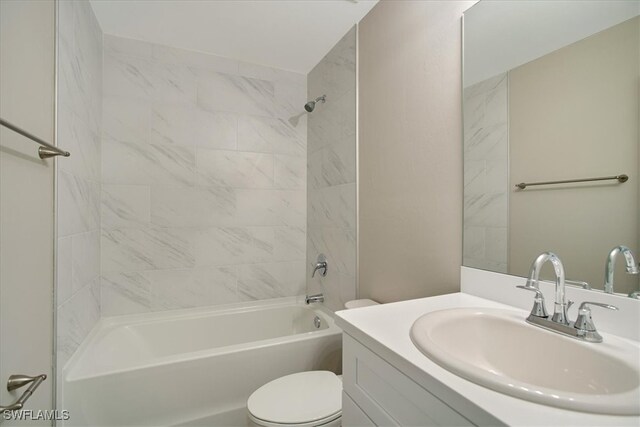 full bathroom featuring vanity, toilet, and tiled shower / bath