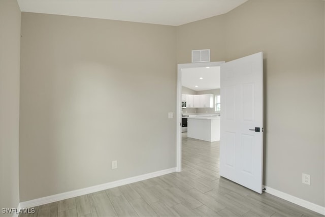 spare room featuring light wood-type flooring