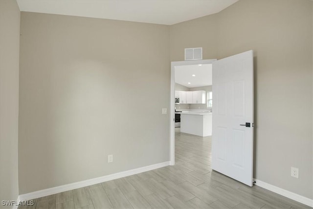 2902 40th St W, Lehigh Acres, FL 33971 - spare room with baseboards, light wood-type flooring, and recessed lighting