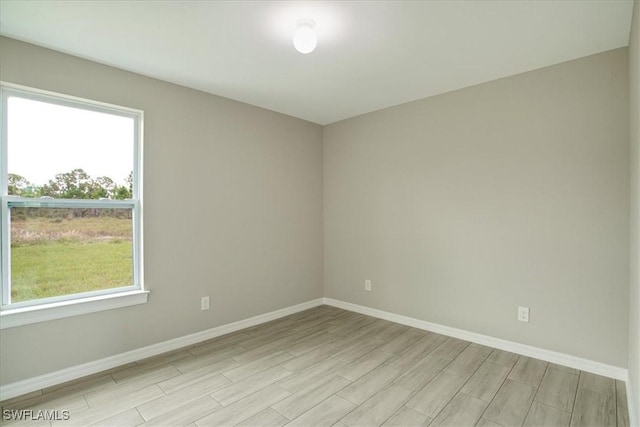 2902 40th St W, Lehigh Acres, FL 33971 - unfurnished room with light wood-type flooring, baseboards, and healthy amount of natural light