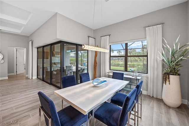 dining space with light hardwood / wood-style flooring and french doors