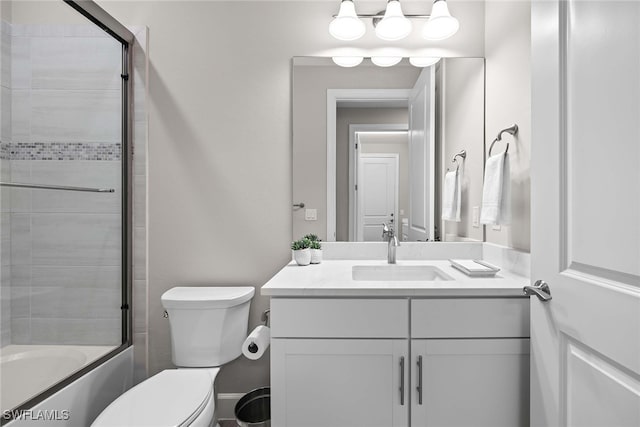 full bathroom featuring vanity, toilet, and combined bath / shower with glass door