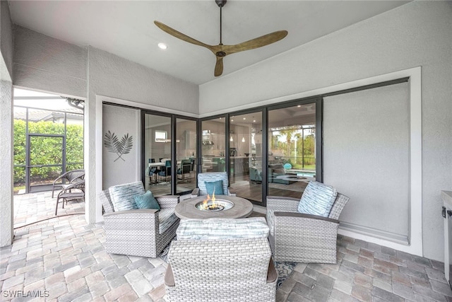 view of patio with a fire pit and ceiling fan