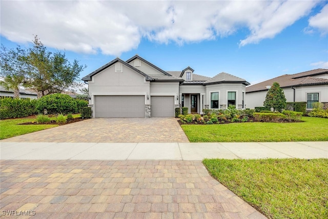 view of front facade with a garage and a front lawn