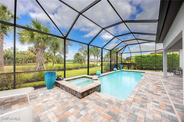 view of pool with glass enclosure, an in ground hot tub, and a patio area