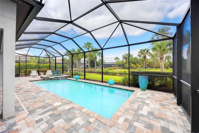 view of pool featuring glass enclosure, a patio area, and an in ground hot tub