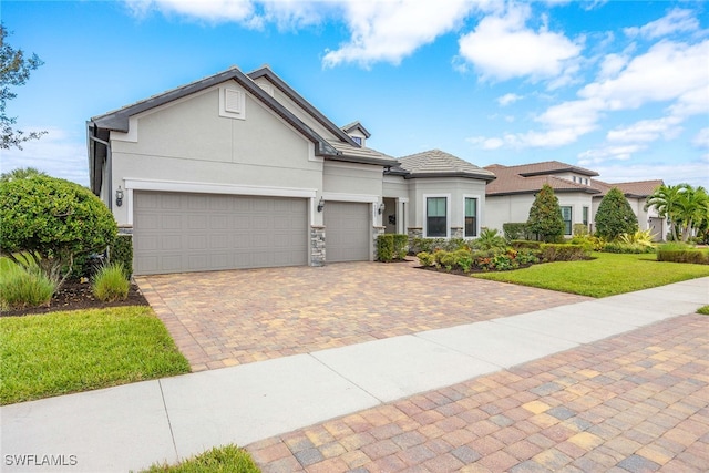 view of front of home featuring a front lawn and a garage