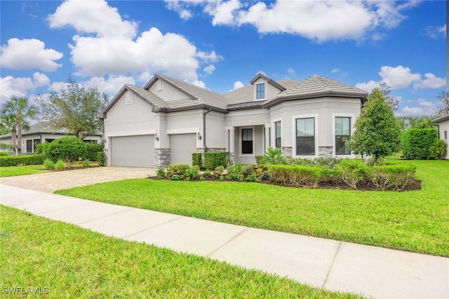 9309 Surfbird Ct, Naples, FL 34120 - view of front of home with stucco siding, stone siding, driveway, and a garage