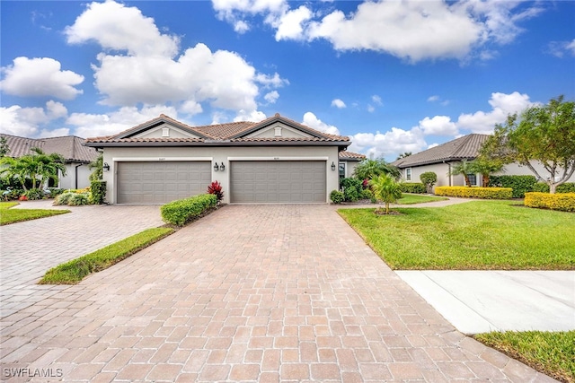 mediterranean / spanish-style home featuring a garage and a front lawn