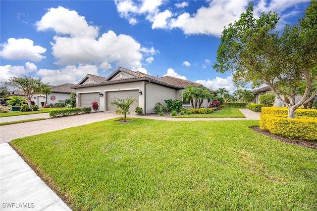 mediterranean / spanish house featuring a garage and a front lawn