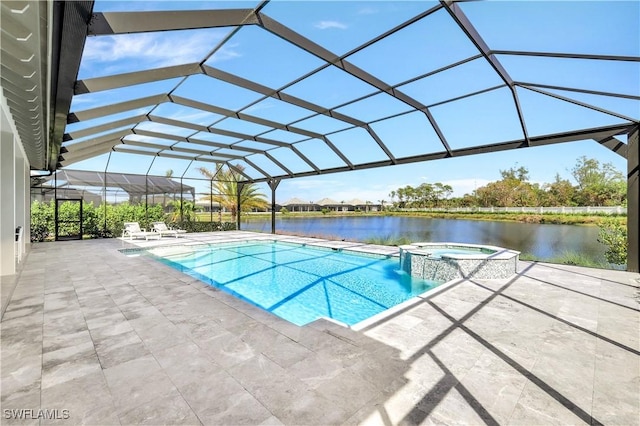 view of pool with an in ground hot tub, a patio, a water view, and glass enclosure