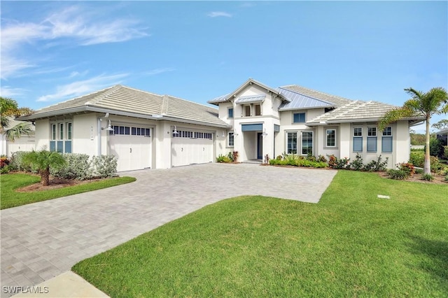 view of front facade with a front yard and a garage