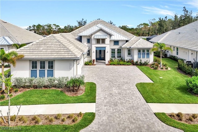 view of front of home with a front yard and french doors