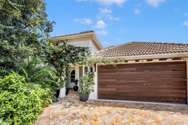 mediterranean / spanish home featuring a garage