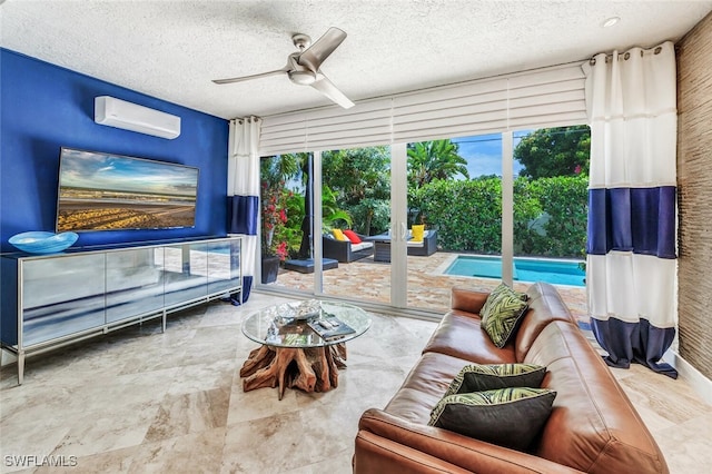 living room featuring a textured ceiling, an AC wall unit, and ceiling fan